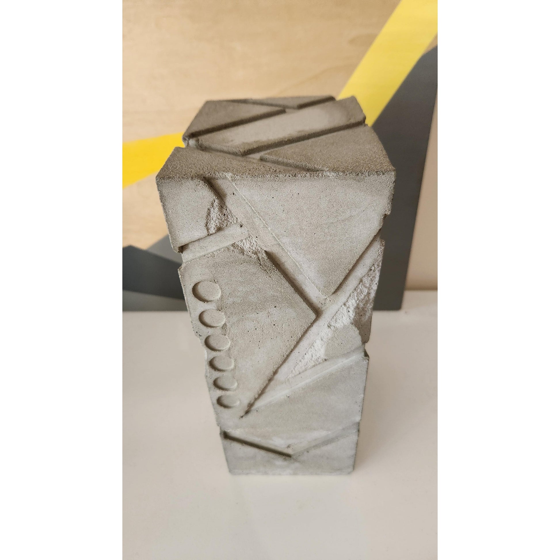 Concrete block with decorative patterns on a plain background