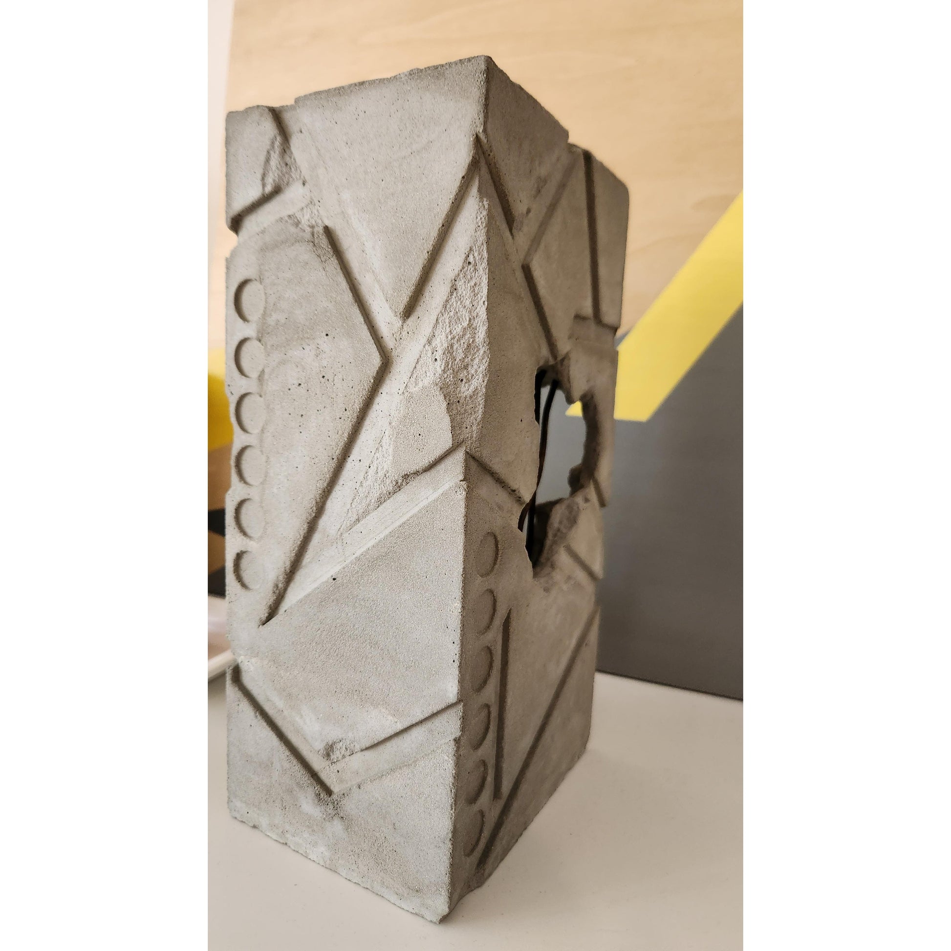 Concrete block with geometric design on a plain background