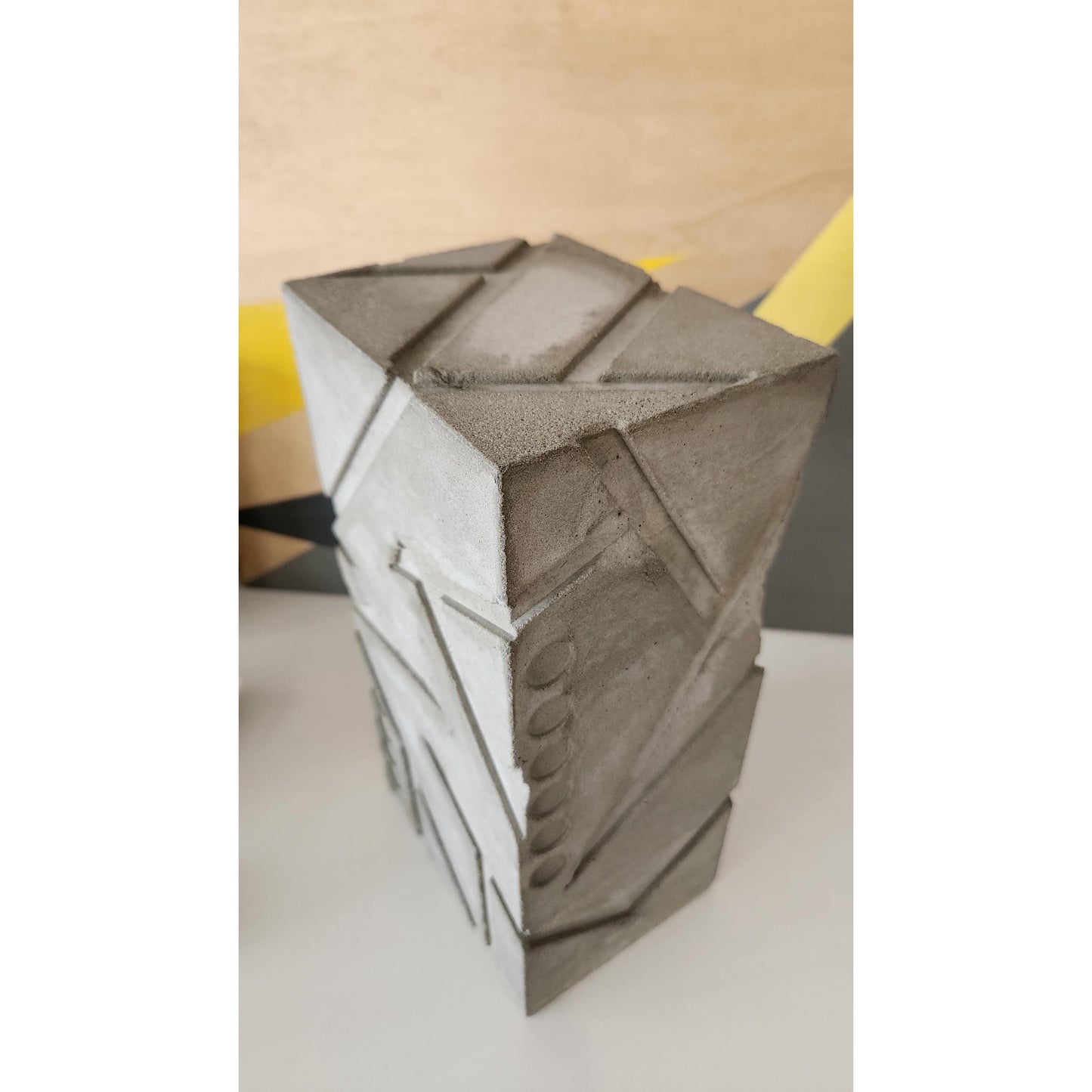 Close-up of a geometric sculpture with a textured surface