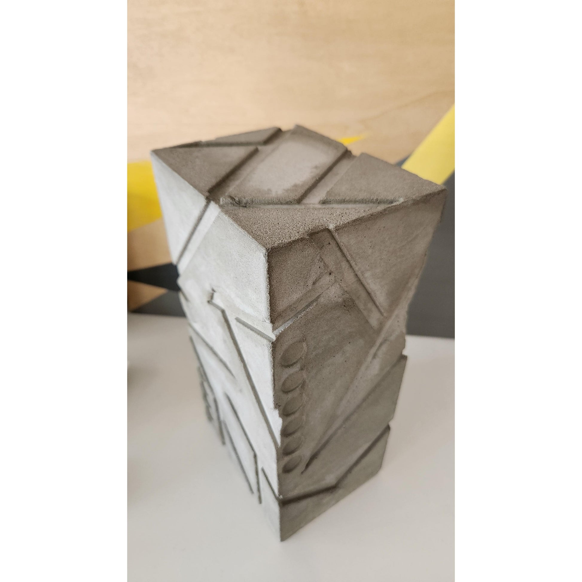 Close-up of a geometric sculpture with a textured surface