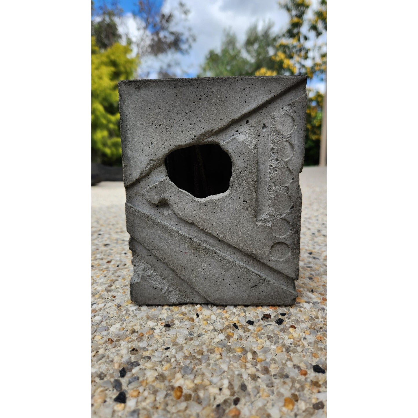 Concrete block with a square hole in a concrete wall