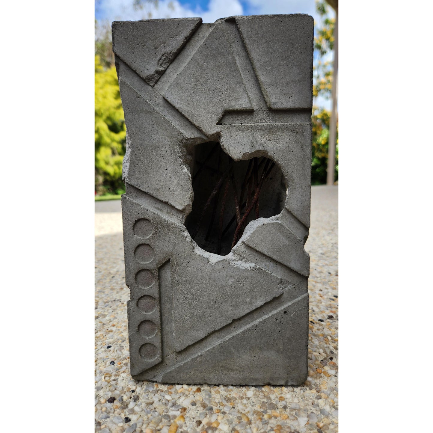 Concrete block with a hole in it on a textured surface