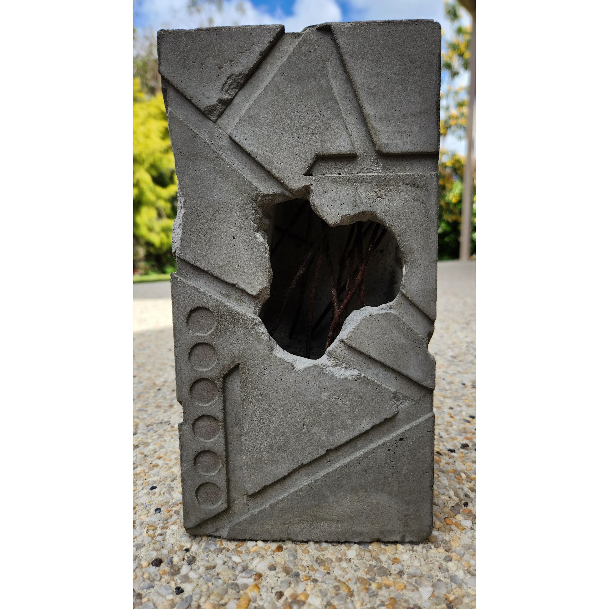 Concrete block with a hole in it on a textured surface